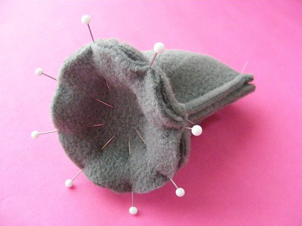 grey fleece circle pinned to a grey fleece tube - showing how to sew a flat bottom when making stuffed animals
